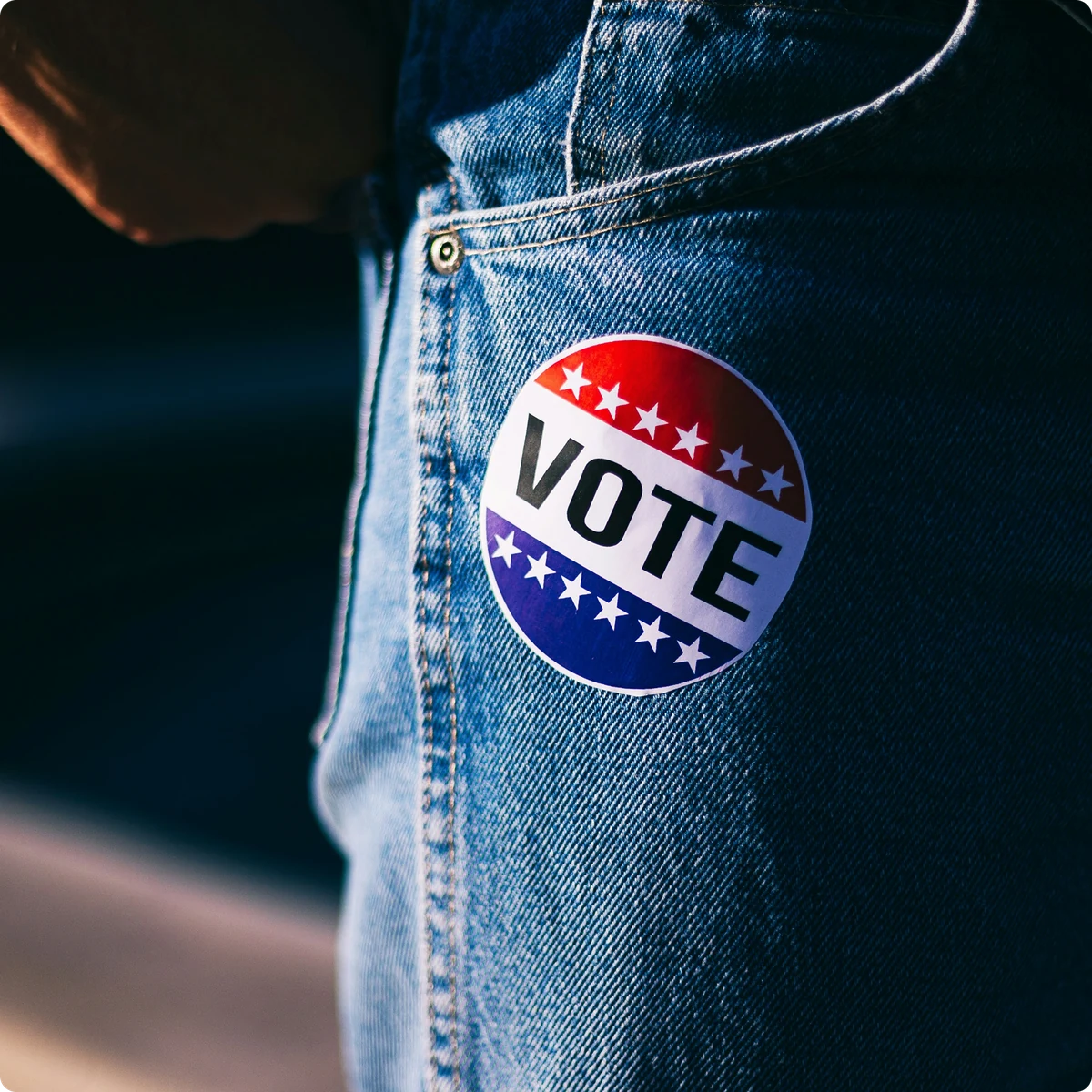 A Vote sticker on denim